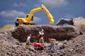 MiniatureÃÂ Contruction workers working lifting stone using shovel Royalty Free Stock Photo